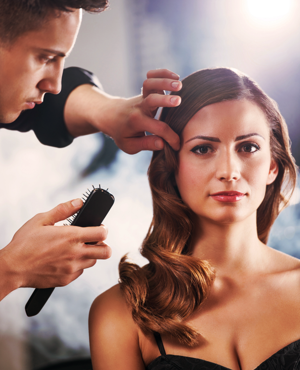 Hairdresser styling woman's hair